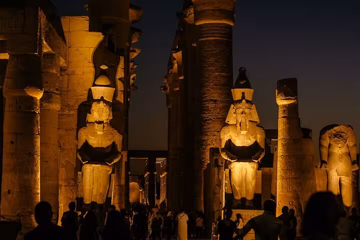 Luxor Temple at night with illuminated Ramses II statues, private full-day Luxor sightseeing tour with lunch
