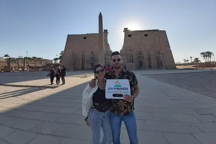 Travelers at Luxor Temple with obelisk on a private Luxor day tour from Cairo by flight, Egypt