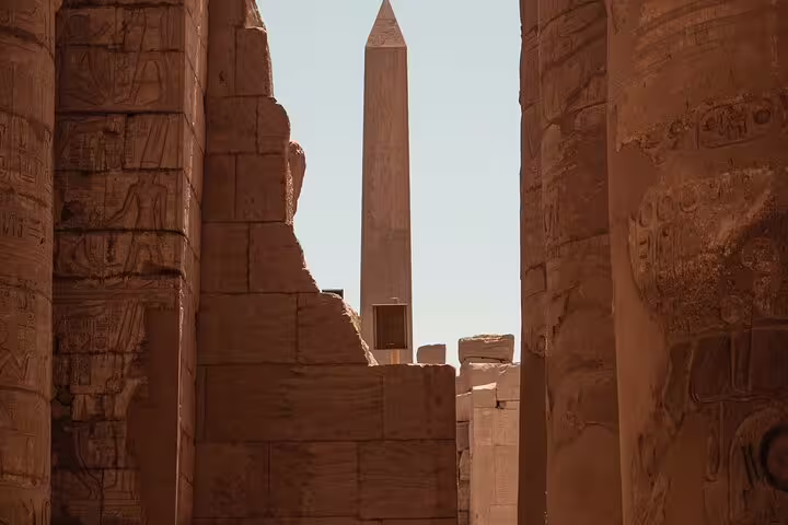 Luxor Temple obelisk framed by ancient sandstone walls on 3 days 2 nights VIP train tour from Cairo
