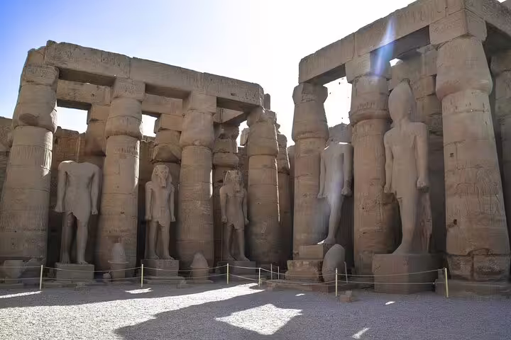 Colonnade with colossal pharaoh statues at Luxor Temple, highlight of 5 days 4 nights Nile cruise tour