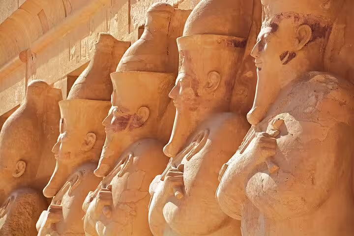 Colonnade of pharaoh statues at Luxor Temple, Egypt, on 3 days 2 nights VIP train tour from Cairo