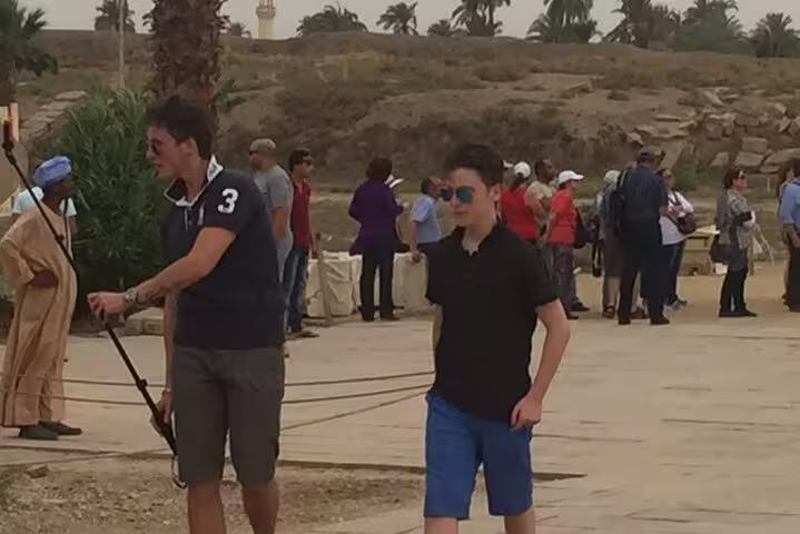 Tourists exploring Luxor temple grounds on a private day trip from Hurghada, Egypt sightseeing tour