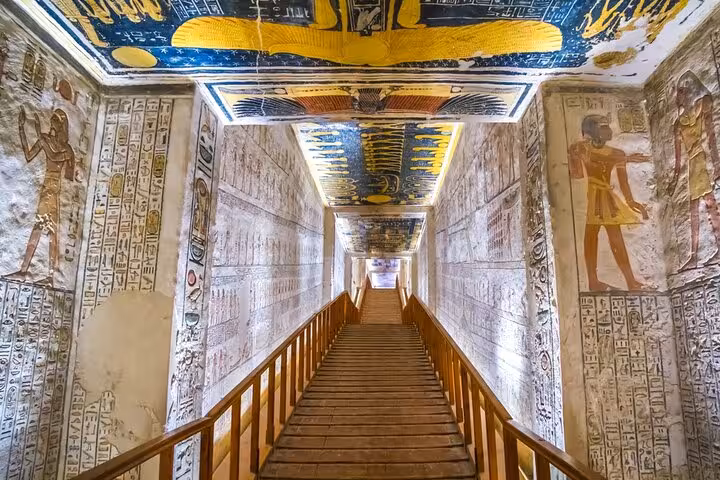 Stairway in Luxor temple tomb with colorful ceiling and hieroglyph walls, tickets included from Marsa Alam