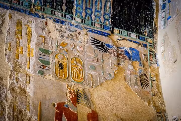 Painted hieroglyphs and winged goddess relief inside Luxor tomb on full-day tour from Marsa Alam