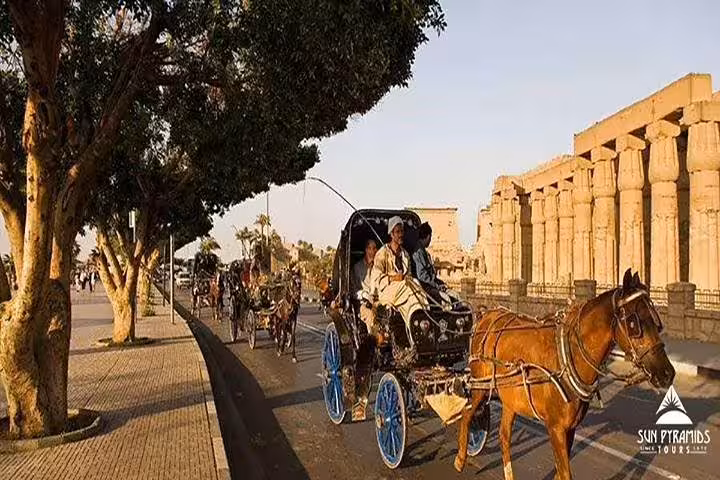 Luxor West Bank horse-drawn carriage tour passing Karnak Temple columns, classic city sightseeing ride