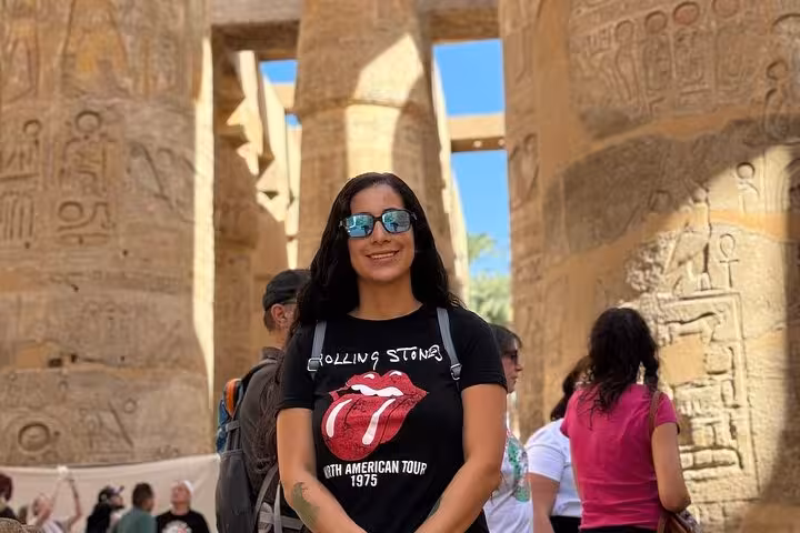 Tourist exploring the ancient Karnak Temple complex, a key attraction on Luxor's West Bank tours.