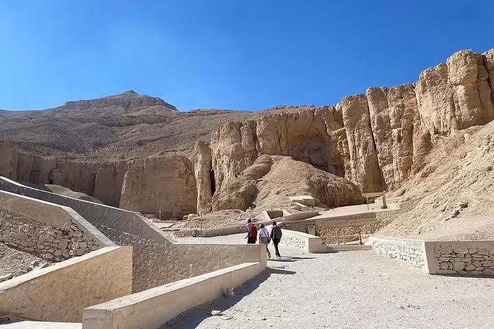 Visitors walk through the rugged landscape of the Valley of the Kings, a key site on the Luxor West Bank tour.