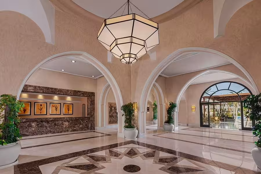Luxurious hotel lobby in Hurghada featuring grand arches, stylish decor, and ample natural light for a welcoming ambiance.