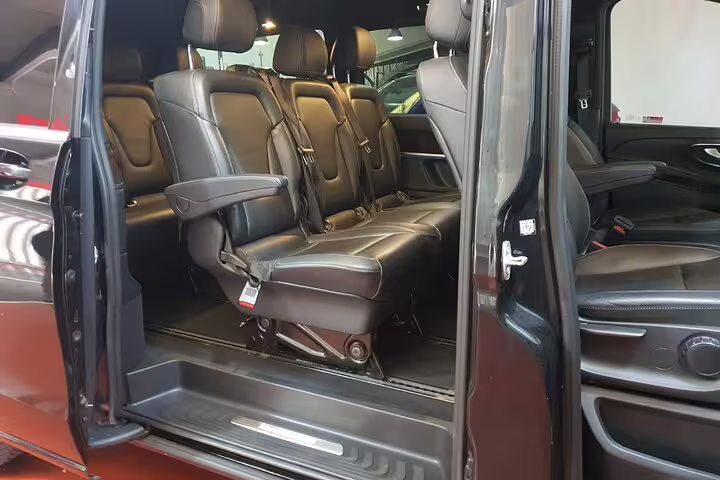 Luxury black van interior with leather seats for private transportation to Madrid Atocha Station from hotel