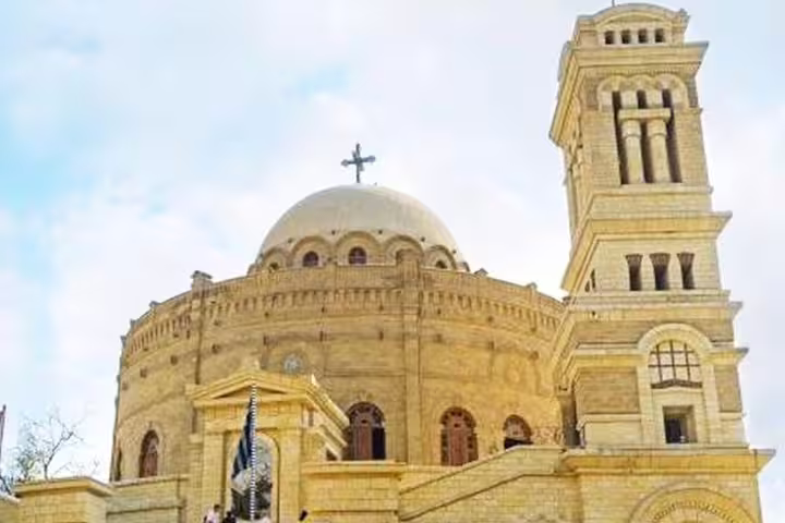 Historic Coptic Cairo church facade and bell tower on a luxury 8-day Cairo and Oberoi Philae Nile cruise tour