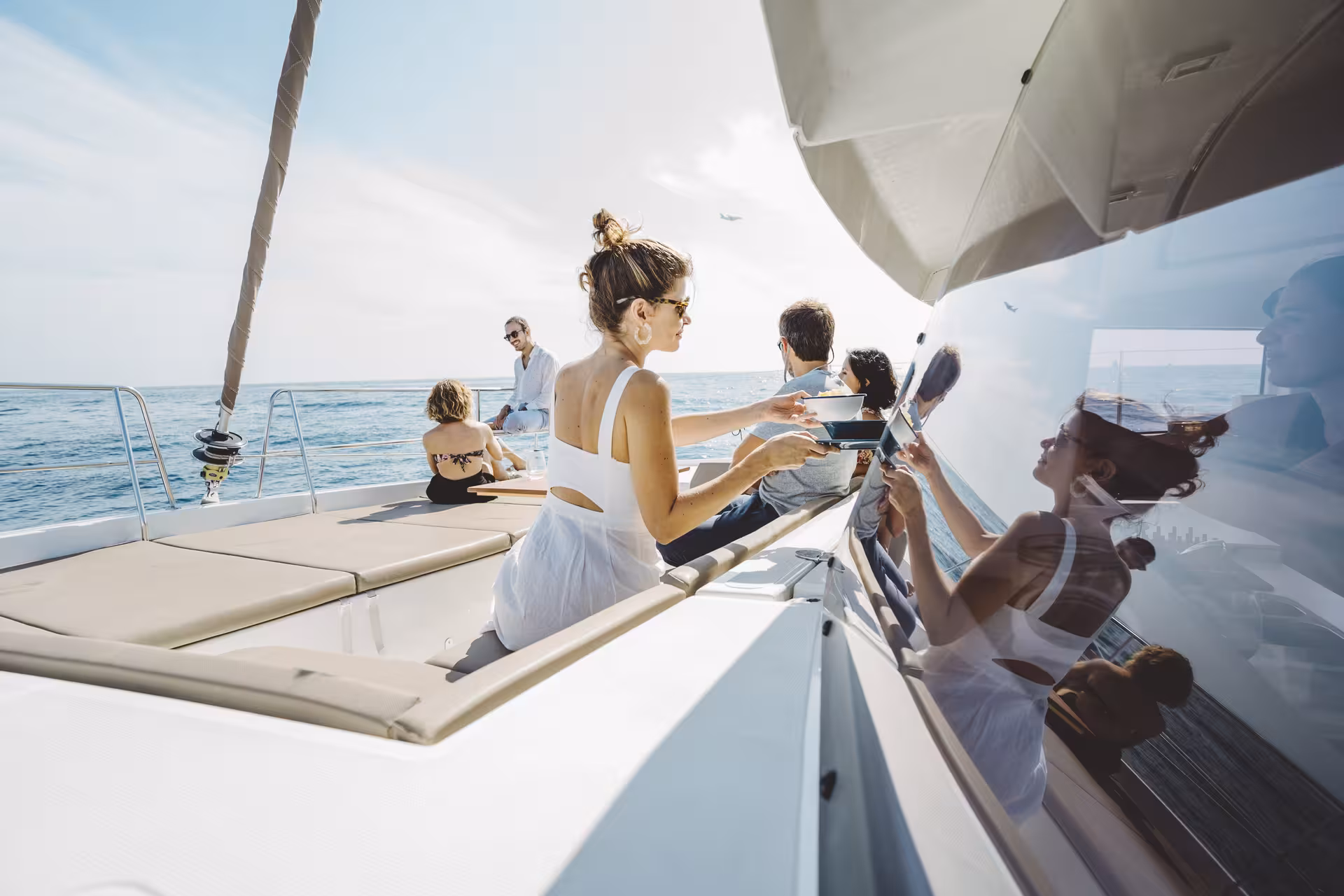 Guests relaxing on Bali 4.1 luxury catamaran deck during 4-hour private Barcelona sailing charter on the Med