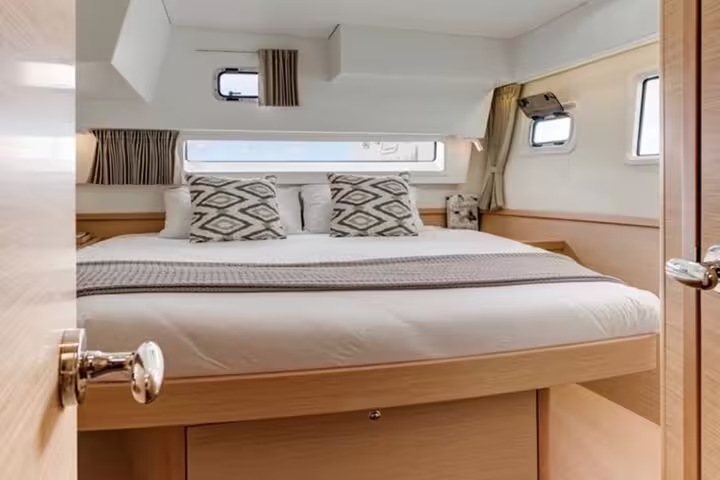 Luxurious double cabin interior on a catamaran offering comfort and relaxation for a half-day tour on Madeira Island.
