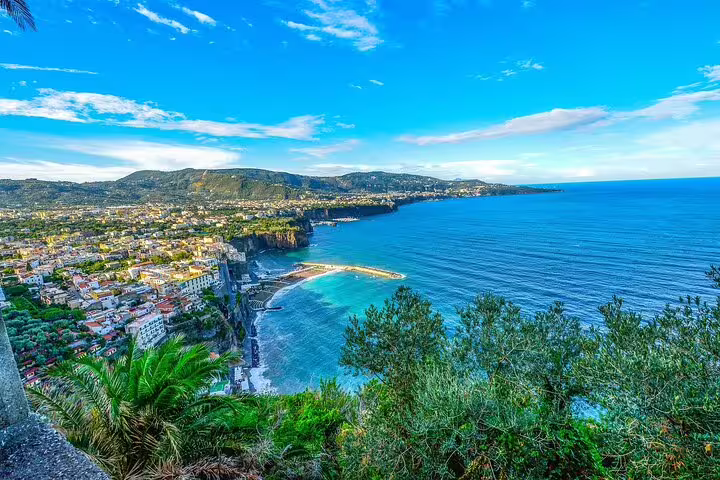 Panoramic view of turquoise bays, cliffs and coastal town from a luxury catamaran sailing along Italy’s stunning Sorrento Peninsula