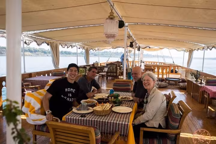 Guests dining on private luxury deluxe Nile dahabiya, 5 days 4 nights cruise with Abu Simbel and balloon
