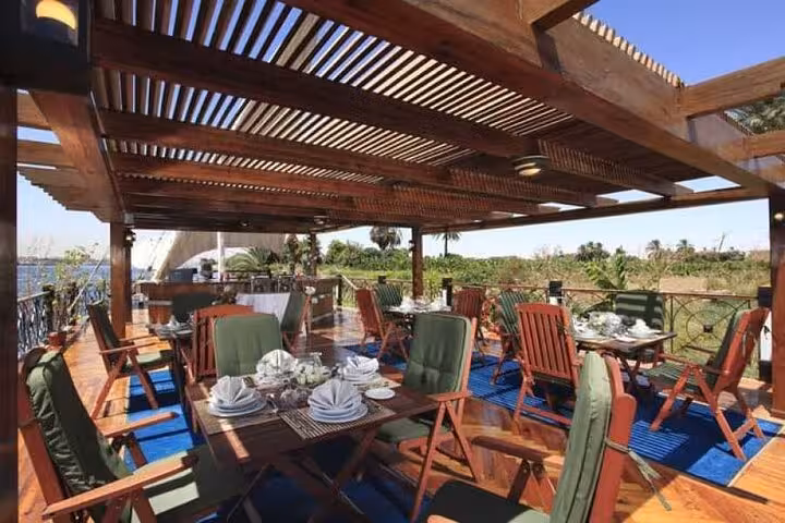 Open-air dining deck on luxury Dahabiya Nile cruise, part of 5-day Abu Simbel and hot air balloon tour