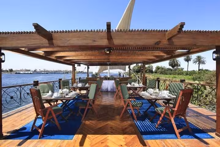 Shaded sundeck restaurant on deluxe Dahabiya Nile cruise near Luxor, included in 5 days Abu Simbel tour