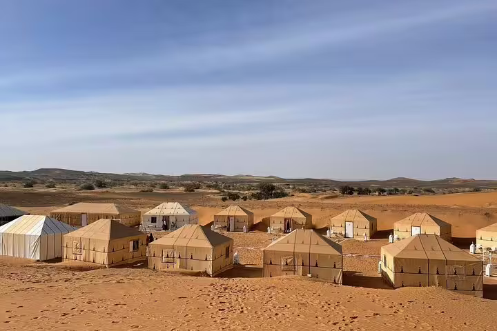 Luxury desert camp tents on golden dunes, Sahara Desert overnight on Morocco 11-day tour from Casablanca via Merzouga