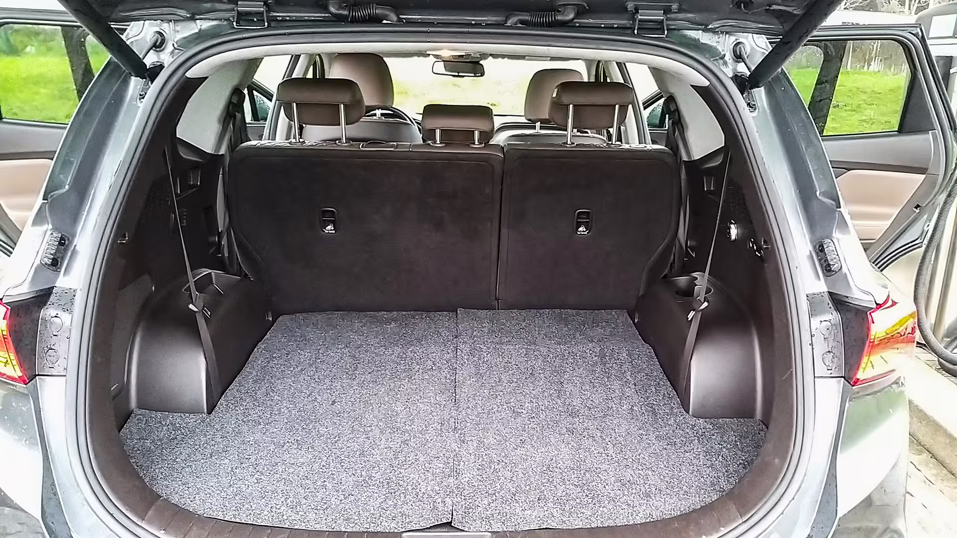 Spacious trunk of luxury executive car showcasing ample luggage space for a private chauffeur service and car hire.