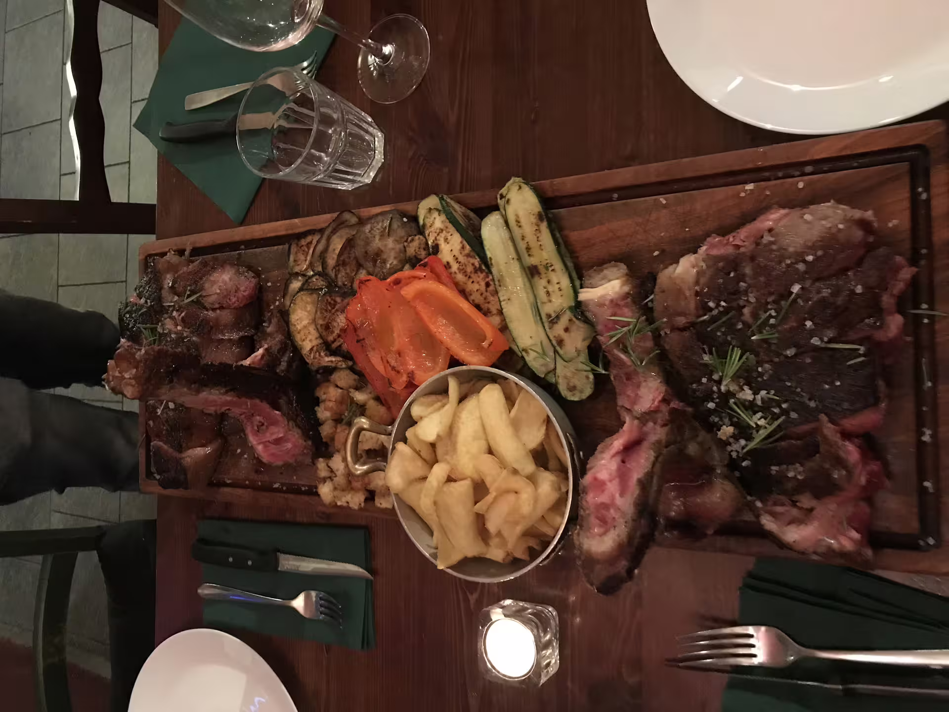 Exquisite meat and vegetable platter with fries, highlighting a premium culinary experience in luxury cooking class.