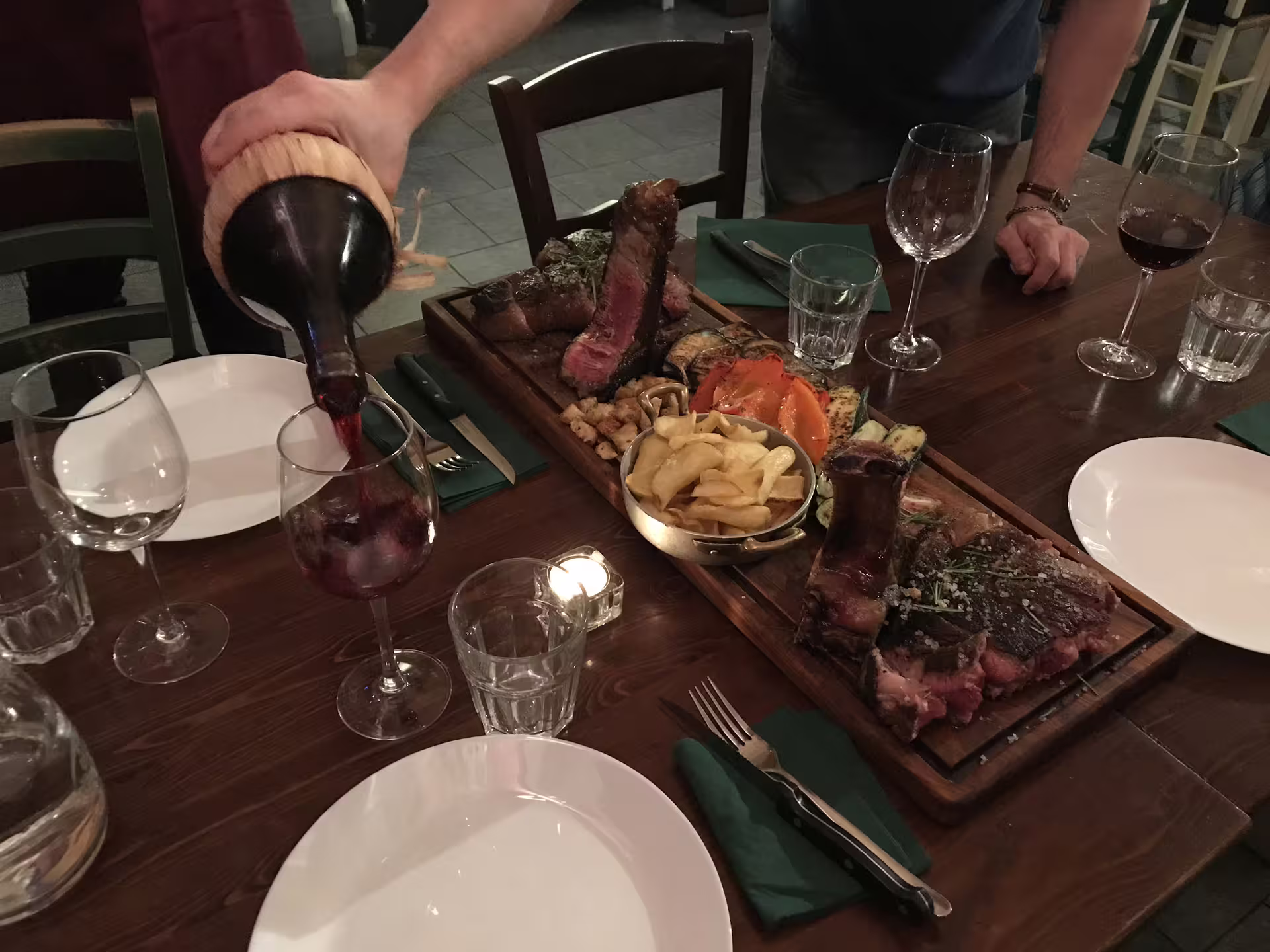 Gourmet meat platter paired with red wine, showcasing a luxurious dining experience at a top cooking class.