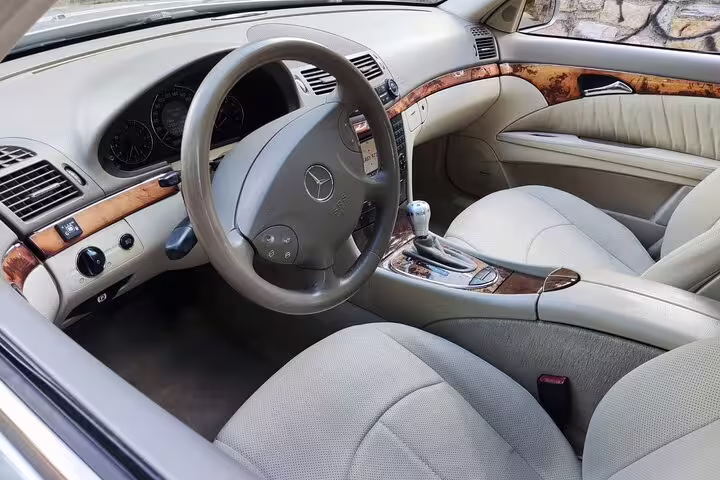 Luxury Mercedes interior with leather seats for Athens private half day tour, comfortable chauffeured transport