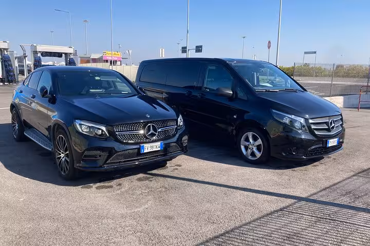 Luxury Mercedes vehicles ready for private transfer from Rome to Fiumicino Airport, ensuring comfort and style.