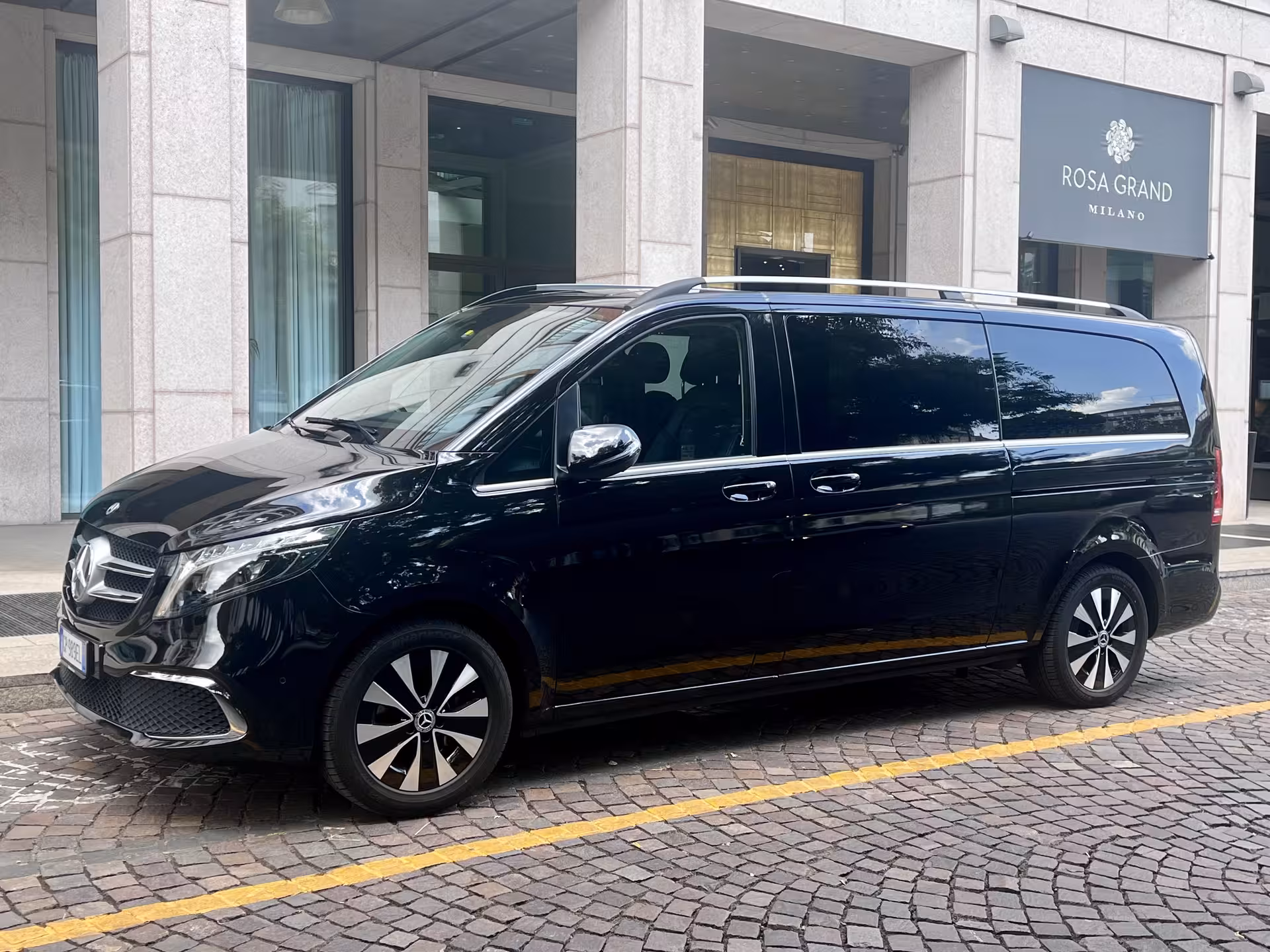 Luxury Mercedes van parked outside Rosa Grand Milano, perfect for Milan to Florence travel comfort and style.