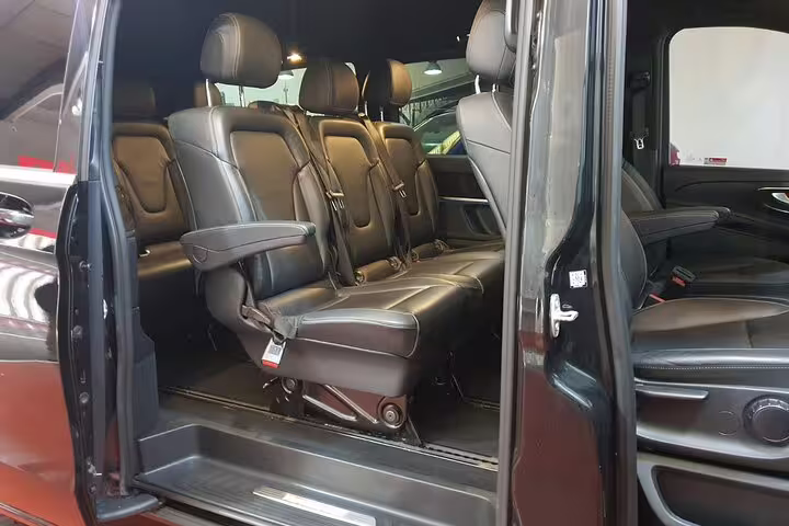 Luxury private minivan interior with leather seats for hotel pickup transfer to Madrid Chamartin train station