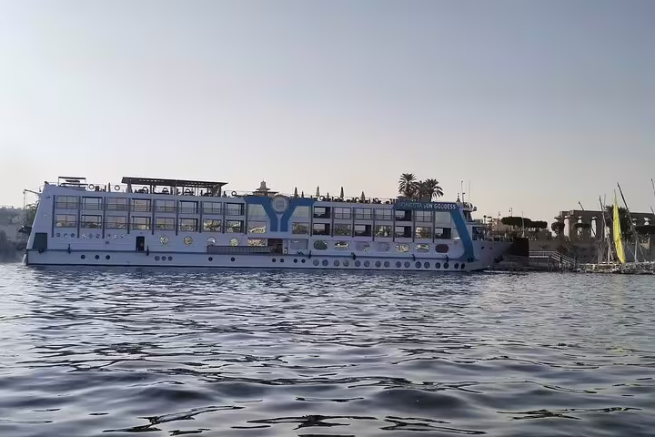 Luxury Nile River cruise ship sailing at sunset near Luxor, part of 12-day Egypt Cairo pyramids and Hurghada tour