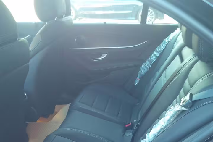 Interior view of a luxury private car with premium leather seating for airport transfers from Treviso to Venice.