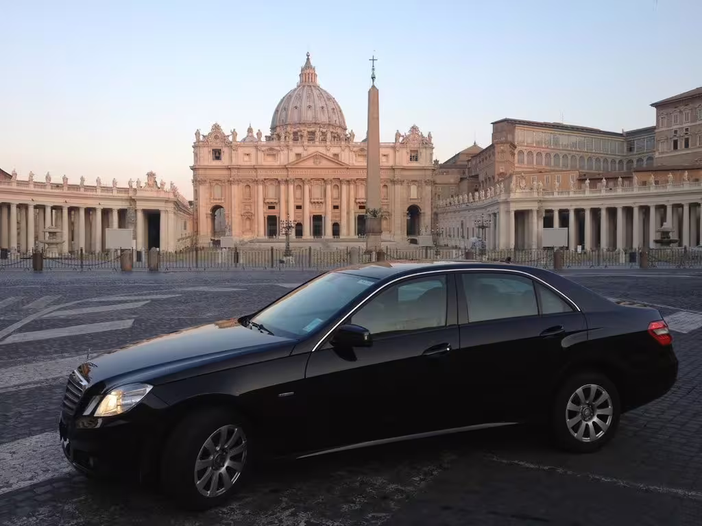 Luxury black sedan parked in St. Peter’s Square at sunrise, starting a private 3-hour sightseeing tour of Rome by car