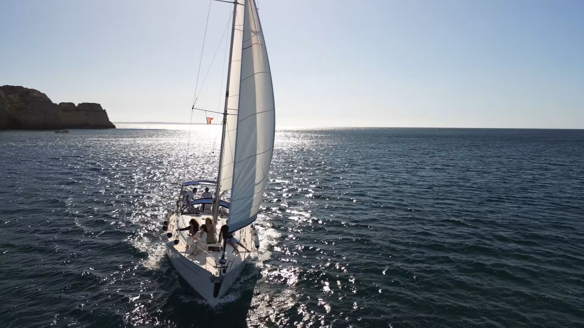 Luxury sailboat gliding on the Atlantic near Lagos, Portugal, on a full-day yacht cruise with coastal scenery
