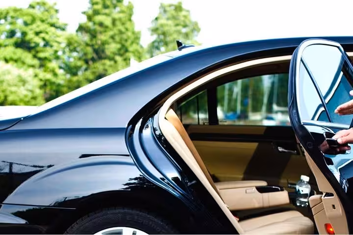 Luxury sedan with open rear door for private transfer from Cairo International Airport to Cairo or Giza