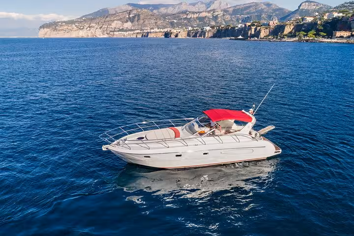 Luxury Shamal 40 boat cruising near Sorrento's stunning coastline on a private tour to the Amalfi Coast.