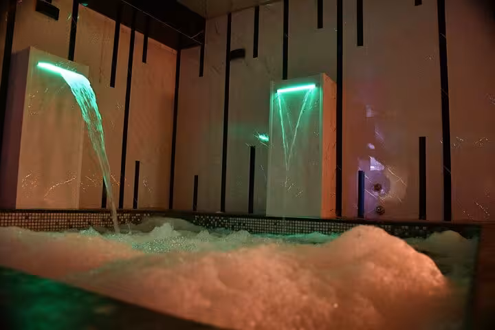 Luxury spa jacuzzi with bubble bath and waterfall lights, VIP solo massage experience in Sharm El Sheikh