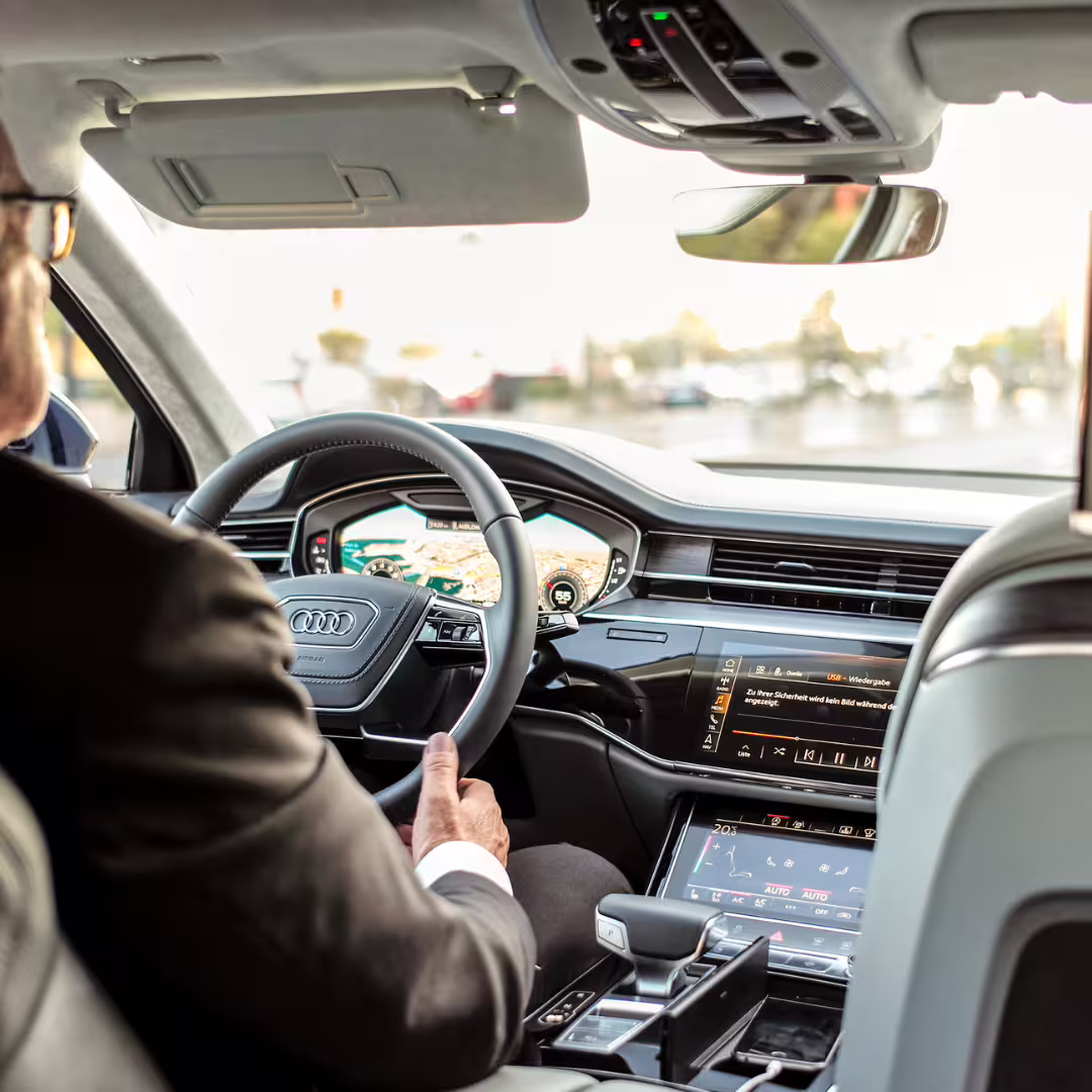 Business chauffeur driving luxury car for private transfer from Naples to Avellino with modern GPS navigation