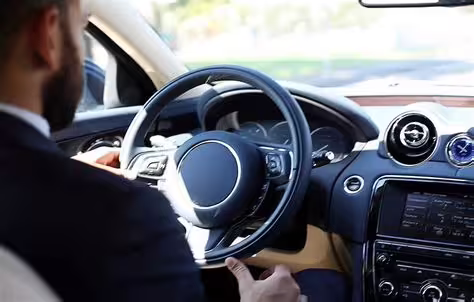 Professional chauffeur driving luxury car for private transfer service between Naples and Paestum archaeological site