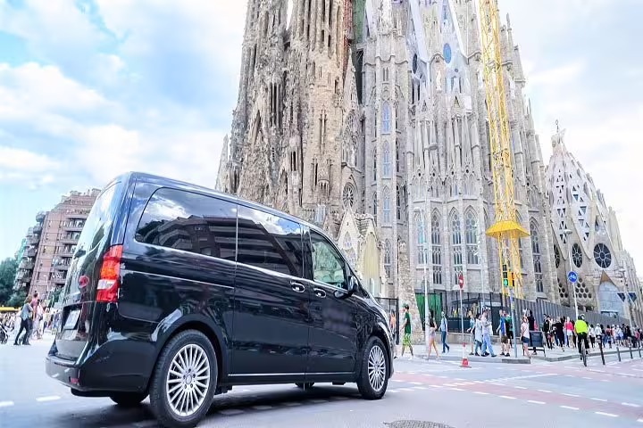 Luxury van parked near Sagrada Familia, a highlight of the Barcelona City + La Roca Village tour.