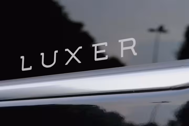 Luxer branding on a sleek vehicle, representing luxury transportation for Venice to Fusina Cruise Terminal transfer.