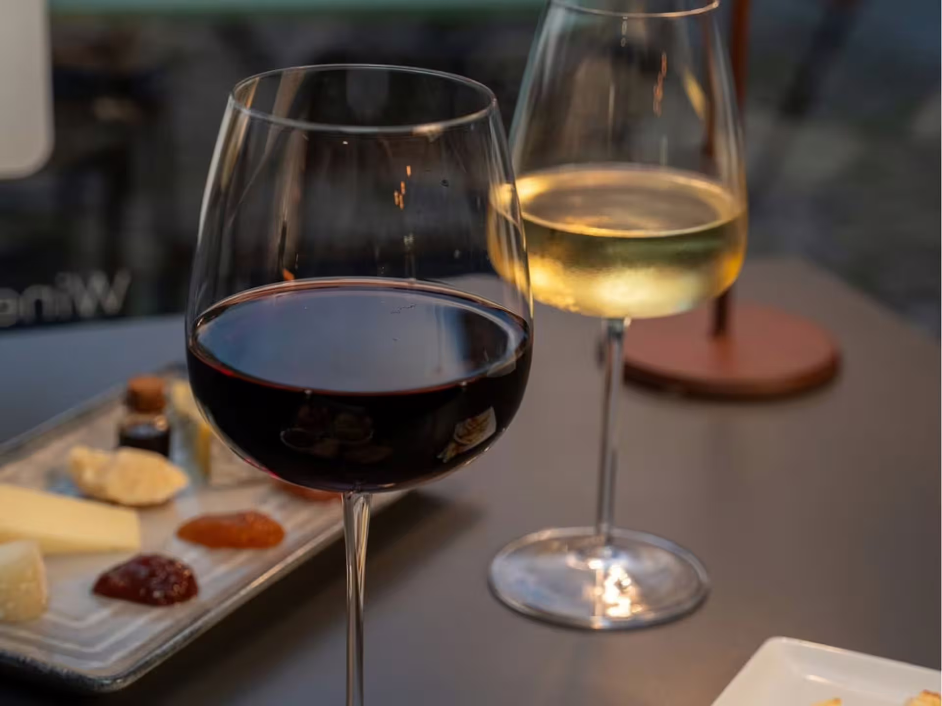 Red and white wine glasses with cheese board, luxury wine tasting in Modena city center experience