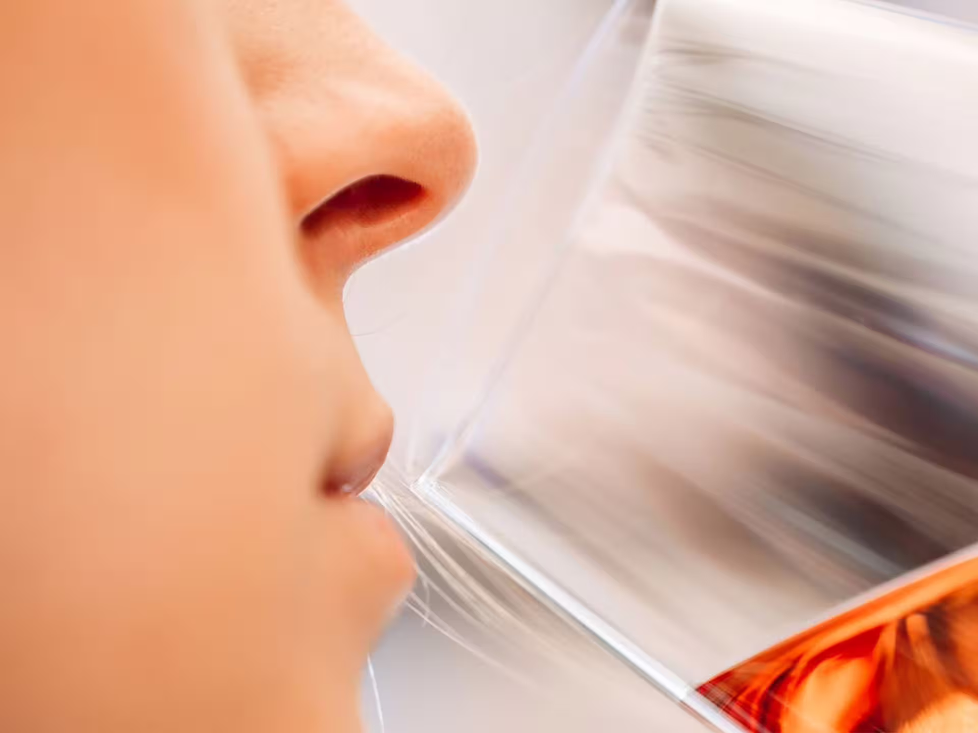 Close-up of guest smelling wine in glass during luxury wine tasting in Modena city center, Italy