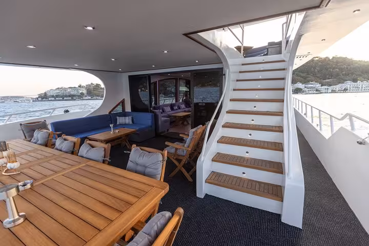 Luxury yacht aft deck dining area with stairs, ideal for private Istanbul Bosphorus yacht cruise tours