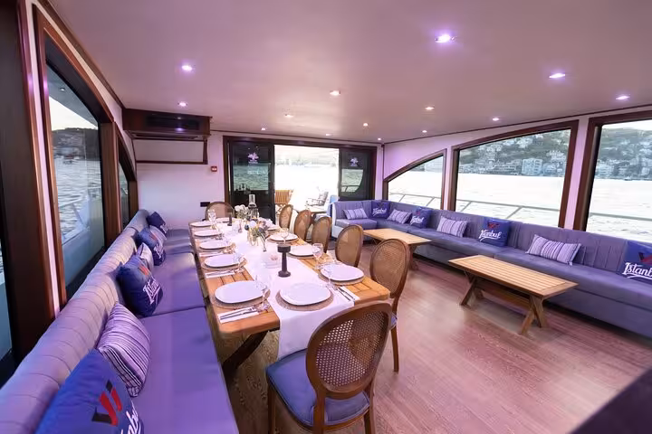 Luxury yacht interior dining setup for a private Istanbul Bosphorus cruise with panoramic sea views