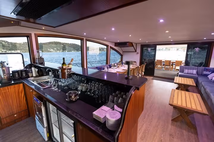 Luxury yacht interior bar and lounge for a private Istanbul Bosphorus cruise, panoramic windows and seating