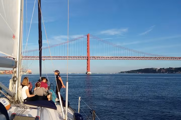 Luxury yacht sailing past 25 de Abril Bridge on Tagus River, Lisbon sailing tour with 2 drinks and skyline views