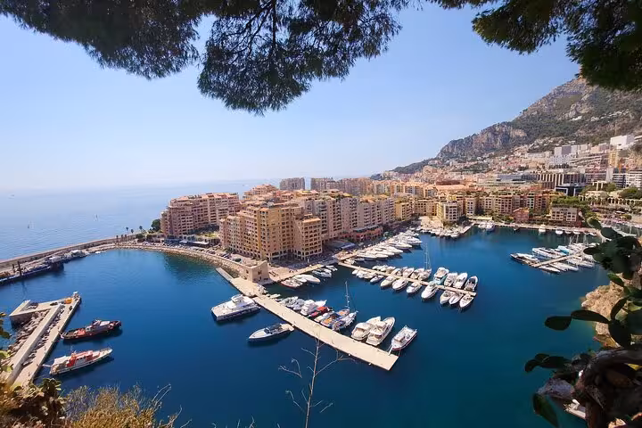 Aerial view of luxury yachts and waterfront buildings in the stunning Port of Monaco on the French Riviera.