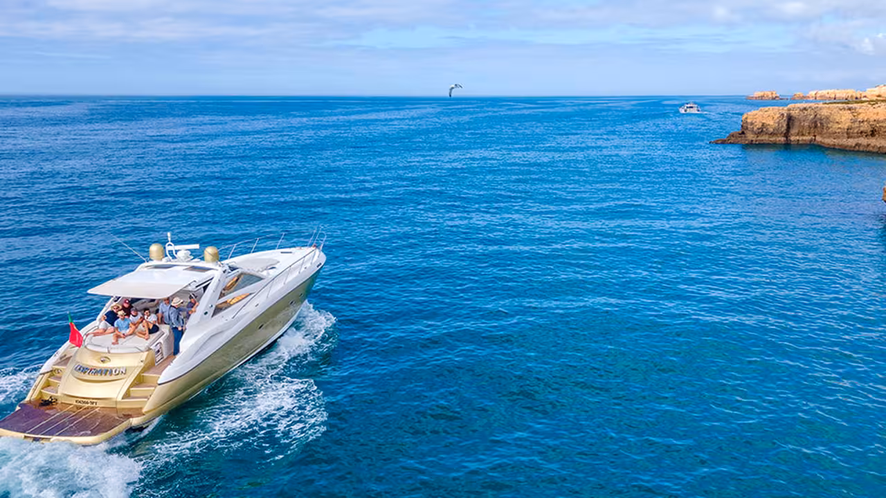 Luxury yacht cruising Algarve coastline near Ponta da Piedade, Lagos, on a full-day sightseeing cruise