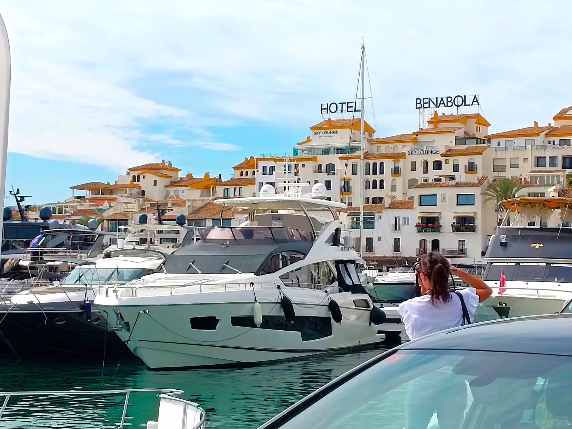 Luxury yachts at Puerto Banus marina Marbella, Hotel Benabola backdrop on private tour with hotel pick-up