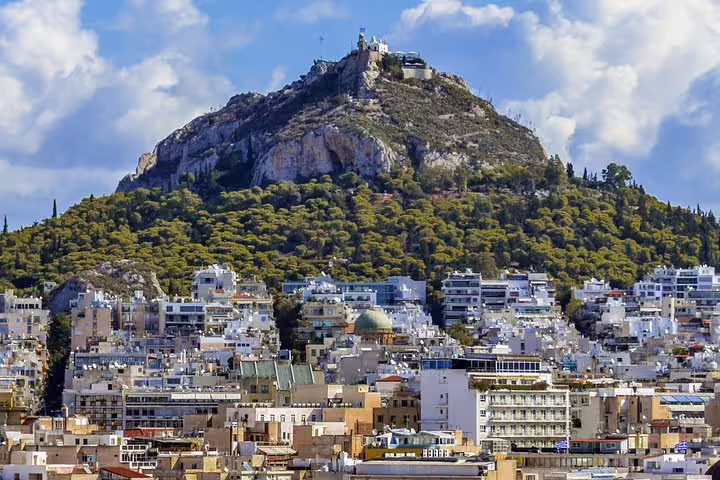 View of Lycabettus Hill above Athens cityscape, scenic stop on an Athens highlights night tour