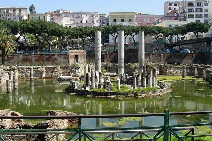 Flooded Macellum of Pozzuoli with Roman columns rising from the water on a guided Phlegraean Fields day trip from Naples